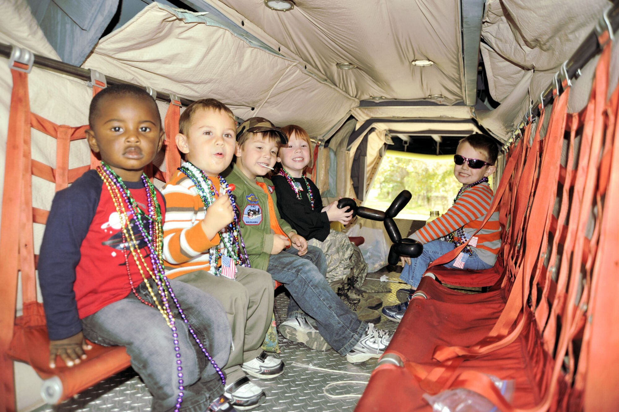 Tyler, Julien, Tyson, Alex and Jackson were the littlest passengers aboard Lil' Bill during the Gulf Coast Veterans Day Parade in D'Iberville, Miss. Nov. 12. Lil' Bill is the 403rd Wing's scale model of a C-130J aircraft. The boys are the children of 403rd Wing members: Tech Sgt. Brandon and Chiquita Goodloe, Senior Master Sgt. Neil and Shannon Sherman, Capt. Justin Pearce, and Maj. Heather Newcomb. (U.S. Air Force photo by Maj. Heather Newcomb)