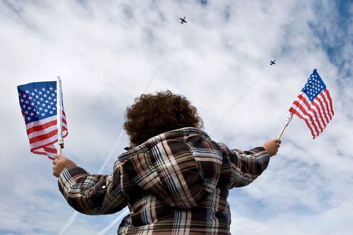 King Long, son of Jeff Long, watches the Patriots Jet Demonstration Team fly over during the 2011 Aviation Nation Open House Nov. 13, at Nellis Air Force Base, Nev. Aviation Nation celebrates 70 years of airpower in Las Vegas and the Air Force's accomplishments in air, space and cyberspace. (U.S. Air Force photo by Senior Airman Brett Clashman/Released)