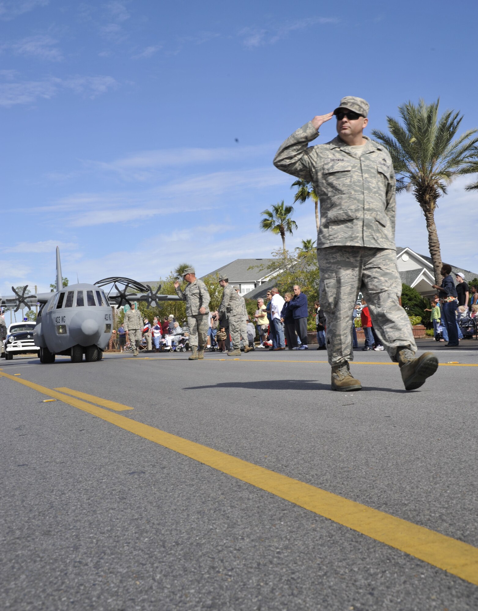 Senior Master Sgt. Neil Sherman salutes as he passes the grand stand on Auto Mall Parkway in D'Iberville, Miss. during the Gulf Coast Veterans Day Parade Nov. 12. Sherman is the senior recruiter of the 403rd Wing and was instrumental in bringing the wing's scale model of a C-130J aircraft, Lil' Bill, to participate in the parade. Lil' Bill is used by the 403rd's Recruiting Squadron during community and recruiting events.(U.S. Air Force photo by Maj. Heather Newcomb)