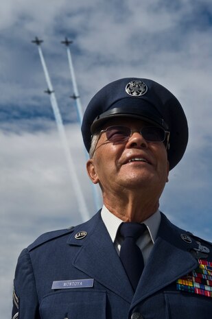 U.S. Air Force Retired Chief Master Sgt. Alfred Montoya, watches The Patriots Jet Demonstration Teams L-39 Albatross  perform maneuvers over the flight line during the 2011 Aviation Nation Open House Nov. 13, at Nellis Air Force Base, Nev. Aviation Nation celebrates 70 years of airpower in Las Vegas and the Air Force's accomplishments in air, space and cyberspace. (U.S. Air Force photo by Airman 1st Class Daniel Hughes/Released)