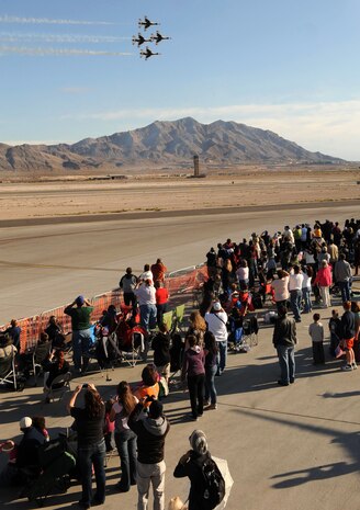 Spectators watch the United States Air Force Air Demonstration Squadron Thunderbirds, perform during the 2011 Aviation Nation Nov. 12, at Nellis Air Force Base, Nev. The Nellis Open House is an opportunity for the Las Vegas community to view aerial demonstrations and static displays of various aircraft from the military signifies the final air show of the year for the Thunderbirds. (U.S. Air Force photo by Staff Sgt. Taylor Worley/Released)