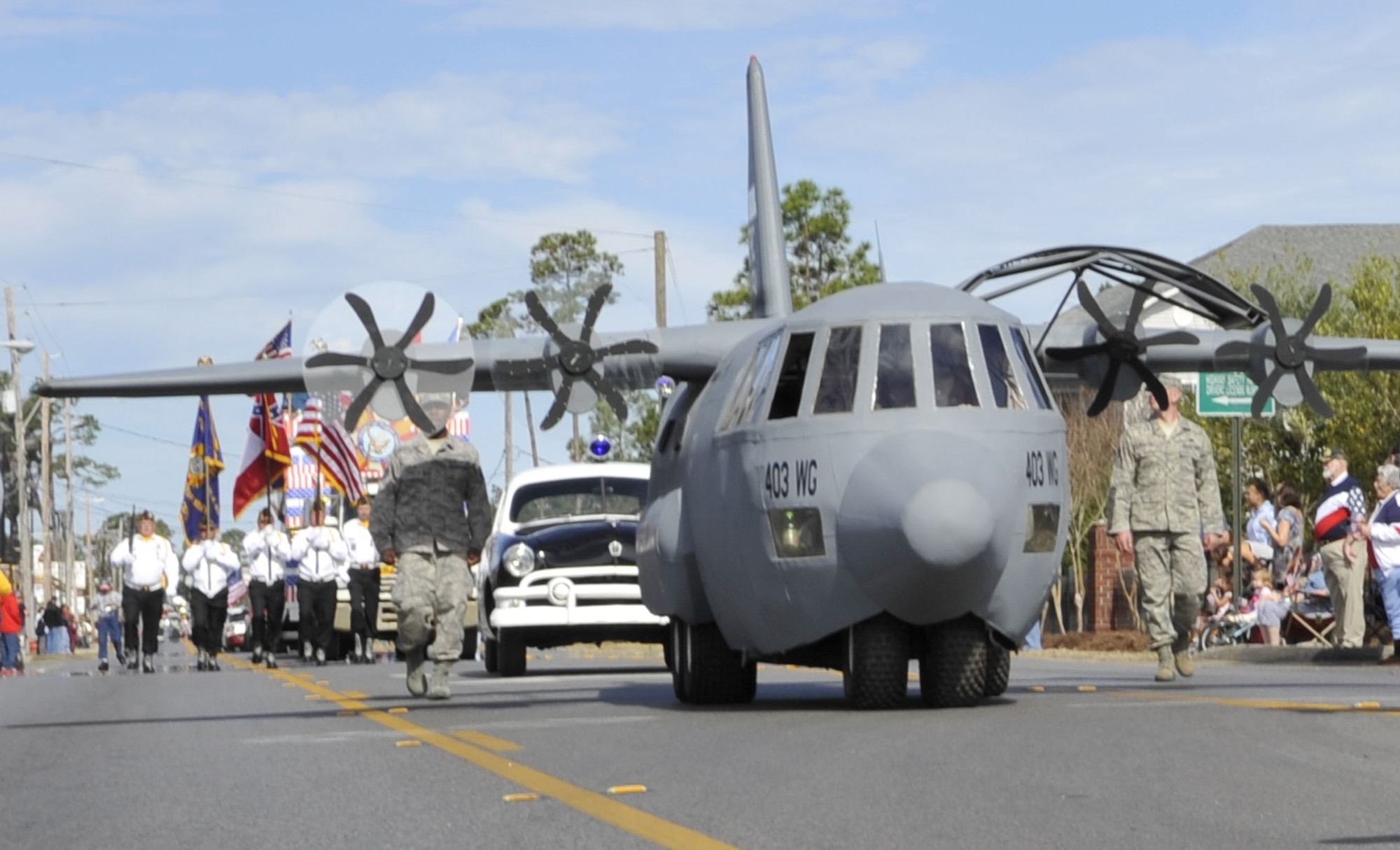 Lil' Bill nears the grand stand on Auto Mall Parkway in D'Iberville, Miss. during the Gulf Coast Veterans Day Parade Nov. 12. Lil' Bill is a scale model of the 403rd Wing's C-130J aircraft and is used by the 403rd's Recruiting Squadron during community and recruiting events.(U.S. Air Force photo by Maj. Heather Newcomb)