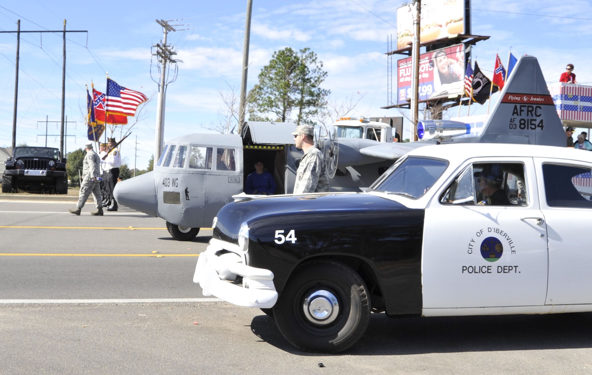 Lil' Bill makes his way down Auto Mall Parkway in D'Iberville, Miss. during the Gulf Coast Veterans Day Parade Nov. 12. Lil' Bill is a scale model of the 403rd Wing's C-130J aircraft and is used by the 403rd's Recruiting Squadron during community and recruiting events.(U.S. Air Force photo by Maj. Heather Newcomb)