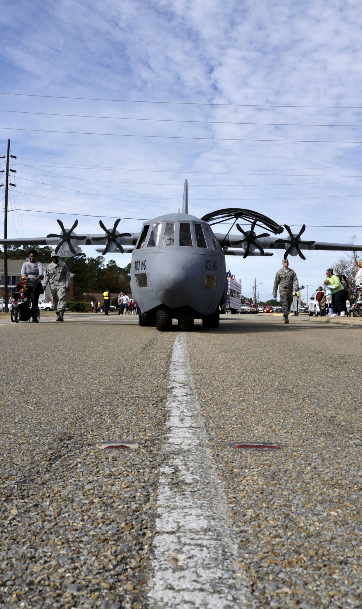 Lil' Bill makes his way down Auto Mall Parkway in D'Iberville, Miss. during the Gulf Coast Veterans Day Parade Nov. 12. Lil' Bill is a scale model of the 403rd Wing's C-130J aircraft and is used by the 403rd's Recruiting Squadron during community and recruiting events.(U.S. Air Force photo by Maj. Heather Newcomb)