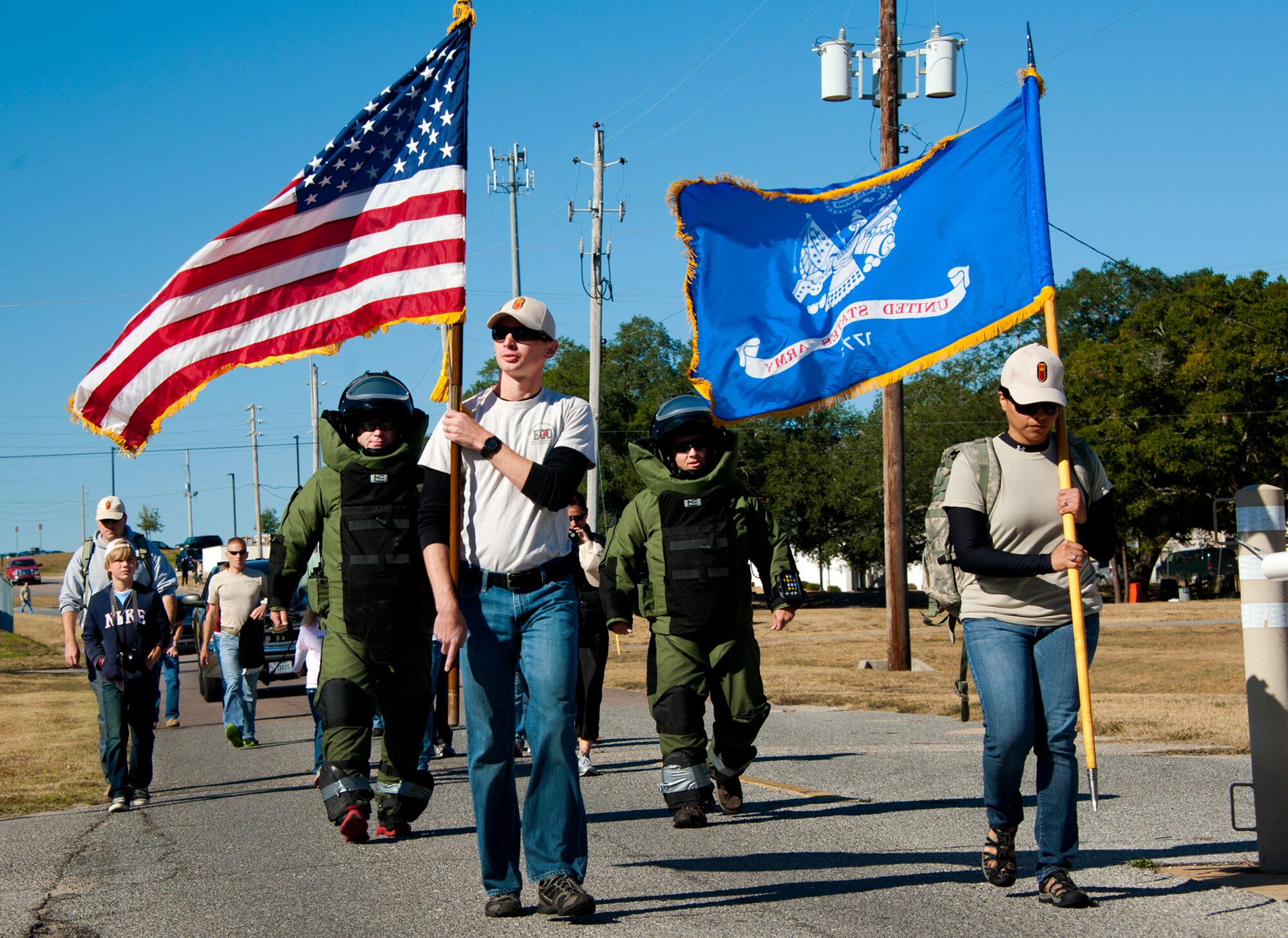 Members of the Army Explosive Ordnance Disposal Training Detachment begin the Veteran's Day Walk Nov. 11 at Eglin Air Force Base, Fla.  Army EOD techs took turns walking from Eglin to the EOD Memorial in the 79-pound bomb suit in two-person teams.  The detachment commander and sergeant major walked the first mile.  (U.S. Air Force photo/Samuel King Jr.) 