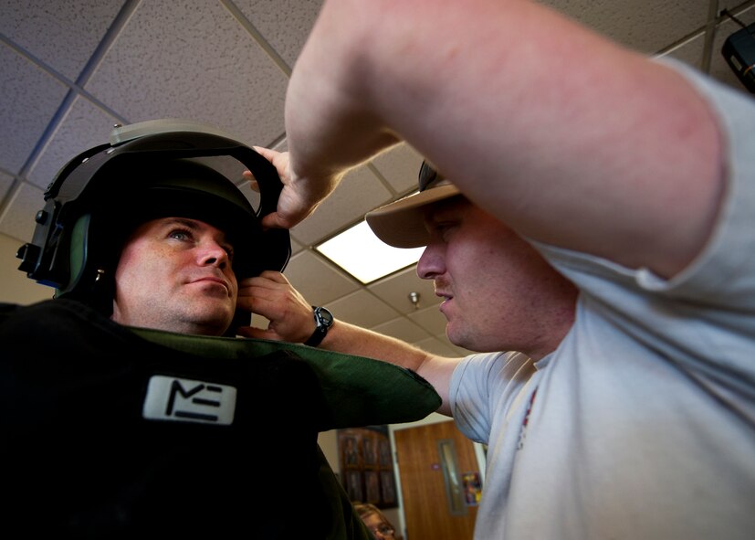 Sgt. Maj. Patrick Standley, of the Army Explosive Ordnance Disposal Training Detachment, puts on the EOD bomb-suit to start the Veteran's Day Walk Nov. 11 at Eglin Air Force Base, Fla.  Army EOD techs took turns walking from Eglin to the EOD Memorial in the 79-pound bomb suit in two-person teams.  The detachment commander and sergeant major walked the first mile.  (U.S. Air Force photo/Samuel King Jr.)