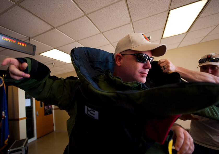 Sgt. Maj. Patrick Standley, of the Army Explosive Ordnance Disposal Training Detachment, puts on the EOD bomb-suit to start the Veteran's Day Walk Nov. 11 at Eglin Air Force Base, Fla.  Army EOD techs took turns walking from Eglin to the EOD Memorial in the 79-pound bomb suit in two-person teams.  The detachment commander and sergeant major walked the first mile.  (U.S. Air Force photo/Samuel King Jr.)