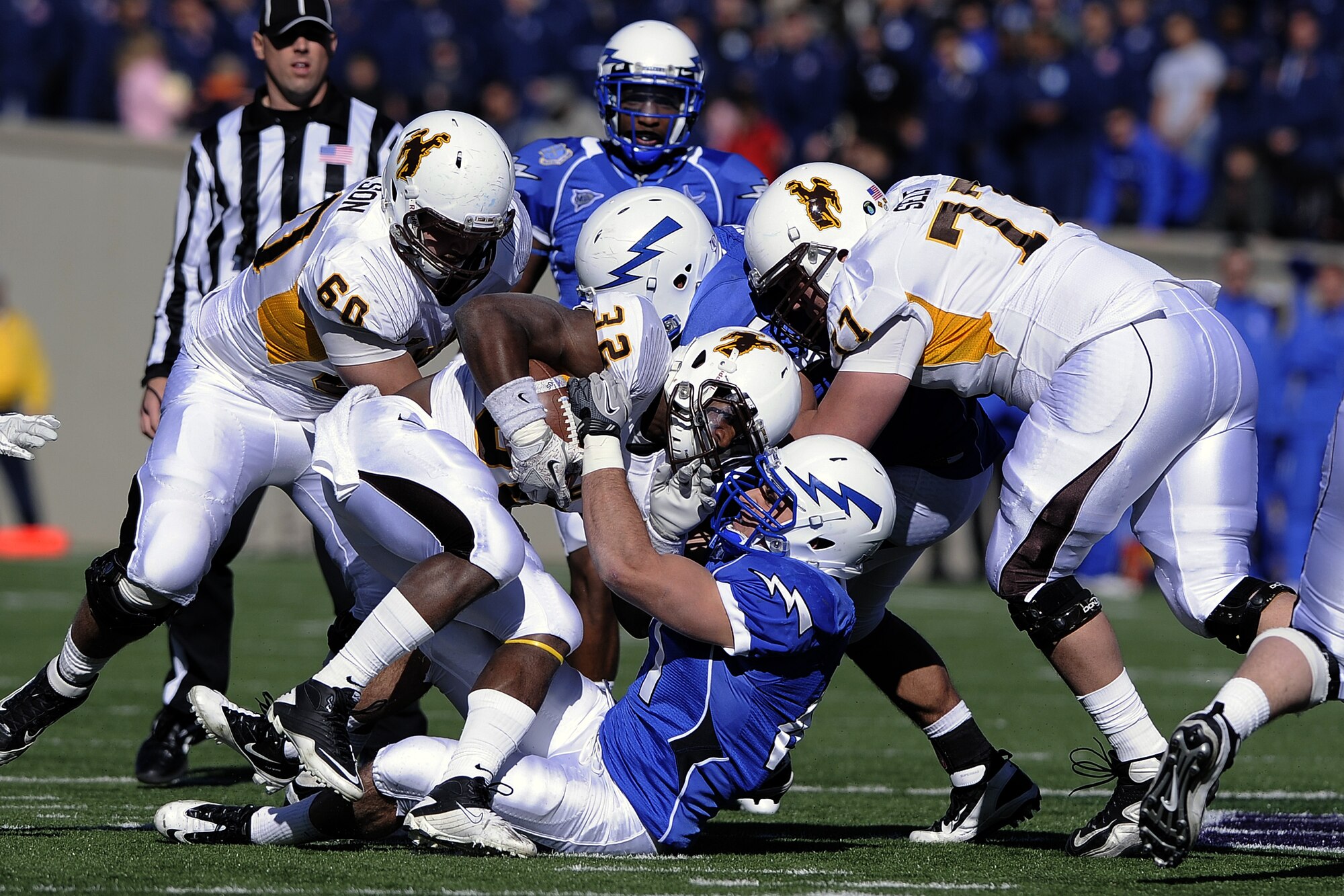 Senior linebacker Brady Amack brings down Wyomings running back Alvester Alexander at the Falcon Stadium Nov. 12, 2011 in Colorado Springs, Colo. The Cowboys defeated Air Force 25-17. (U.S. Air Force photo/Mike Kaplan)