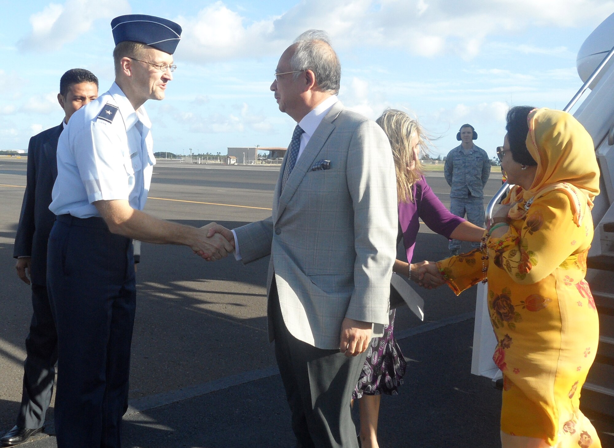 Brig. Gen. Mark McLeod, Headquarters Pacific Air Forces Director of Logistics, welcomes Malaysia’s Prime Minister Datuk Seri Najib Tun Razak to Joint Base Pearl Harbor-Hickam, as Gladys Boluda, U.S. State Department Assistant Chief of Protocol, greets the prime minister’s wife Datin Seri Rosmah Mansor for the Asia-Pacific Economic Cooperation summit, Nov. 11.  Hosting responsibilities have rotated among APEC economies over the succeeding 18 years, with Japan welcoming President Obama and other APEC Leaders to Yokohama in November 2010. (U.S. Air Force photo/Maj. Alysia Harvey)