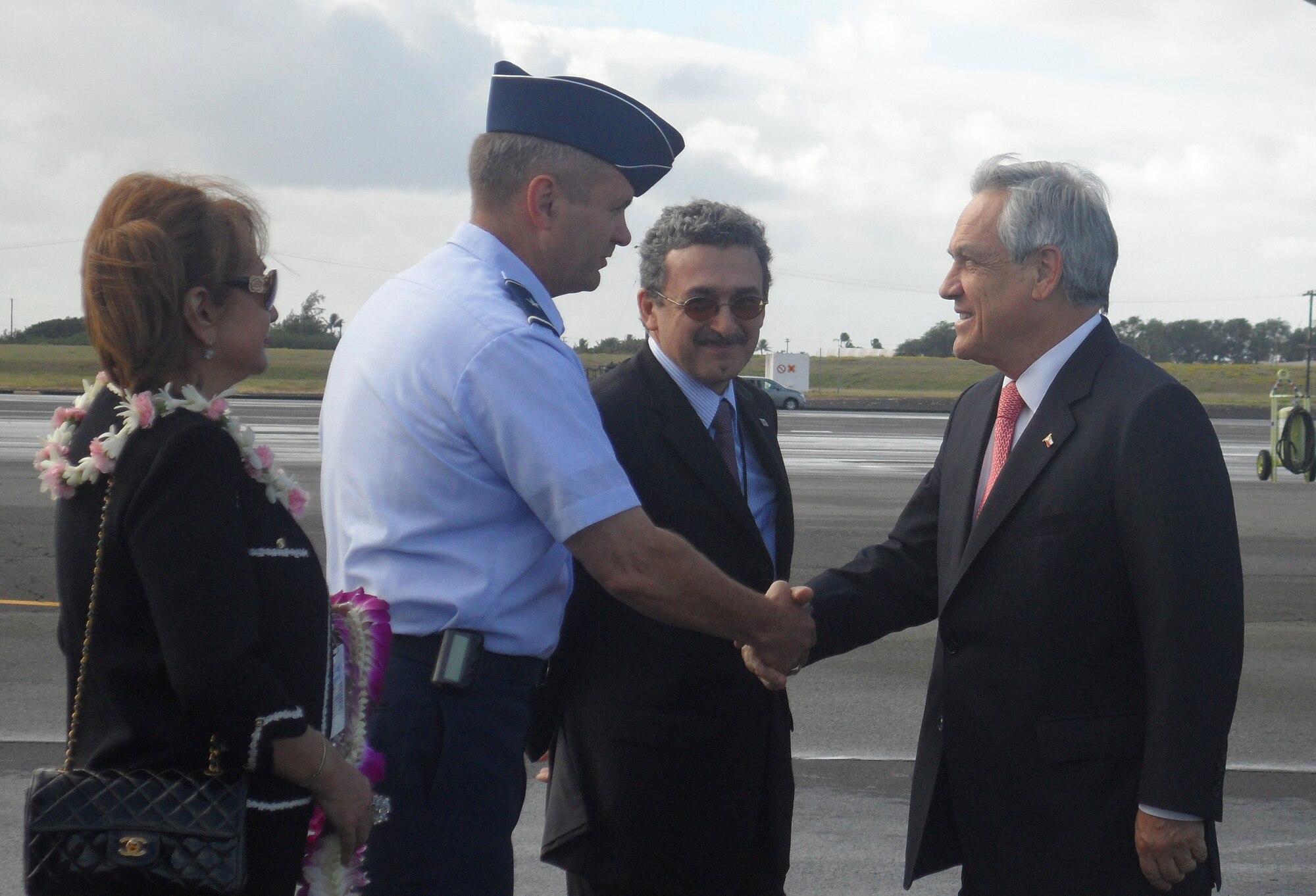 Brig. Gen. Scott West, Headquarters Pacific Air Forces Deputy Director of Operations, Plans, Requirements and Programs, welcomes Chile's President Sebastian Pinera to Joint Base Pearl Harbor-Hickam, for the Asia-Pacific Economic Cooperation summit, Nov. 11.  In 1993, President Bill Clinton invited fellow APEC Leaders to meet on Blake Island near Seattle, elevating APEC from ministerial to head-of-government level for the first time.  Leaders of 21 economies from around the Pacific Rim attended APEC 2011 in Honolulu, Hawaii. (U.S. Air Force photo/Maj. Alysia Harvey)