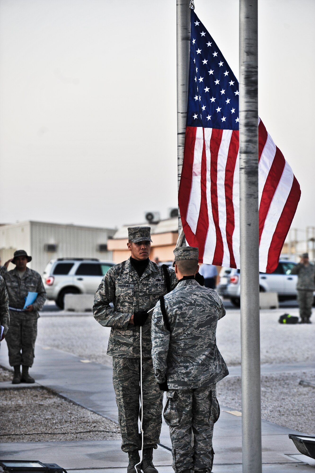 Staff Sgt. Ismael Rodriguez, 34th Aircraft Maintenance Unit, lowers the American Flag during a Veterans Day ceremony Nov. 11, 2011, at an undisclosed location in Southwest Asia. Rodriguez, a native of San Francisco, Calif., is deployed from Ellsworth Air Force Base, S.D. (U.S. Air Force photo/Senior Airman Paul Labbe)