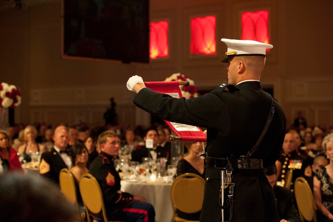 A Marine reads "The General's Message" during the Commandant's Marine Corps Ball in National Harbor, Md., Nov. 12, 2011. The message was originally published by Major Gen. John Lejeune as a guideline for Marines on how to celebrate the Marine Corps' birthday. It is now read every year.