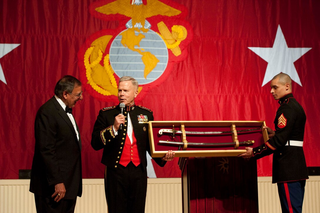 Marine Corps Commandant Gen. James F. Amos, center, presents Defense Secretary Leon E. Panetta with a mameluke sword during the Commandant's Marine Corps Ball in National Harbor, Md., Nov. 12, 2011. The sword is carried by all Marine Corps officers and was first presented to Marine First Lt. Presley O'Bannon by the Ottoman Empire viceroy during the first barbary war.