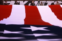 EAST RUTHERFORD, N.J. -- Marines wave back to a cheering crowd after a pregame ceremony before the  the New York Jets vs New England Patriots game, Nov. 13. The West Point Band performed at half time and 100 service members presented the large flag during the National Anthem. (Official Marine Corps photo by Cpl. Caleb Gomez / RELEASED)