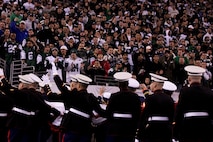 EAST RUTHERFORD, N.J. -- Marines wave back to a cheering crowd after a pregame ceremony before the  the New York Jets vs New England Patriots game, Nov. 13. The West Point Band performed at half time and 100 service members presented the large flag during the National Anthem. (Official Marine Corps photo by Sgt. Randall A. Clinton / RELEASED)