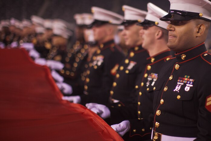 EAST RUTHERFORD, N.J. -- Marines, Sailors, Coast Guardsmen, Airmen and Soldiers unfurled an American Flag across the field during a pre-game ceremony before the New York Jets vs New England Patriots game, Nov. 13. The West Point Band performed at half time and 100 service members presented the large flag during the National Anthem. (Official Marine Corps photo by Sgt. Randall A. Clinton / RELEASED)