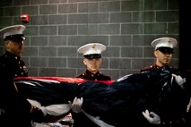 EAST RUTHERFORD, N.J. -- A Marine holds a portion of a large American Flag prior to an on-field ceremony before the he New York Jets vs New England Patriots game, Nov. 13. The West Point Band performed at half time and 100 service members presented the large flag during the National Anthem. (Official Marine Corps photo by Sgt. Randall A. Clinton / RELEASED)