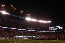 EAST RUTHERFORD, N.J. -- Marines wave back to a cheering crowd after a pregame ceremony before the  the New York Jets vs New England Patriots game, Nov. 13. The West Point Band performed at half time and 100 service members presented the large flag during the National Anthem. (Official Marine Corps photo by Cpl. Caleb Gomez / RELEASED)