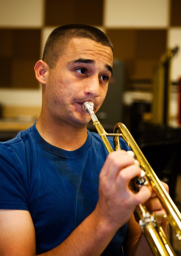 Cpl. Paul A. Tafoya (second from right), a trumpet player with the U.S. Marine Corps Forces, Pacific Band, practices with other band members at the band hall here Nov. 14 for an upcoming holiday concert. Tafoya is on temporary additional duty orders to the band from his normal specialty of being an electro-optical ground ordnance repairer and technician.