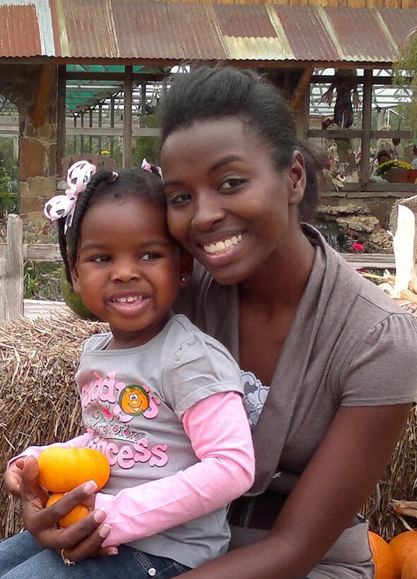Sgt. Teresia Kamau, the training chief for 8th Marine Corps District, sits with her daughter at a pumpkin patch in Fort Worth, Texas. While Kamau holds four administrative billets at the district she still finds time to spend with Olivia to help her grow into an independent person. Kamau was named 8th MCD Marine of the Quarter for the third quarter and Marine of the Year for fiscal year 2011 in which she competed against 24 other Marines.
