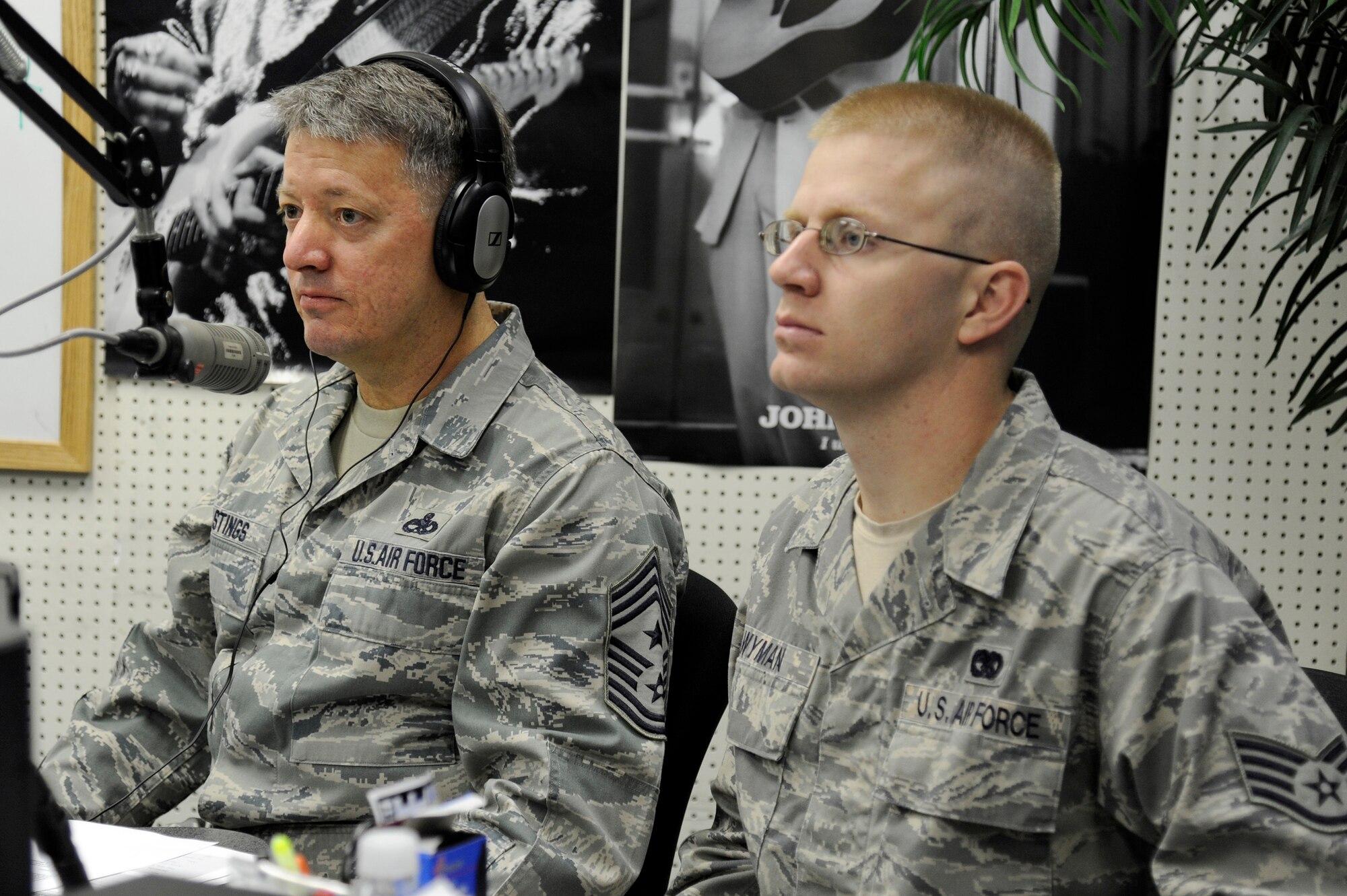 MISAWA AIR BASE, Japan -- Chief Master Sgt. Russell Hastings, left, 35th Fighter Wing command chief, and Staff Sgt. Scott Wyman, 35th Logistics Readiness Squadron, listen to topics of discussion during the Commanders Open Line radio show here Oct. 28. Sergeant Wyman is the first junior enlisted member selected by the Focus 5/6 organization to shadow Chief Hastings during a 3-day mentorship program. The program gives a junior enlisted member the opportunity to shadow the command chief to various meetings, luncheons, briefings and anything else the chief may have on his calendar. (U.S. Air Force photo/Tech. Sgt. Marie Brown)
