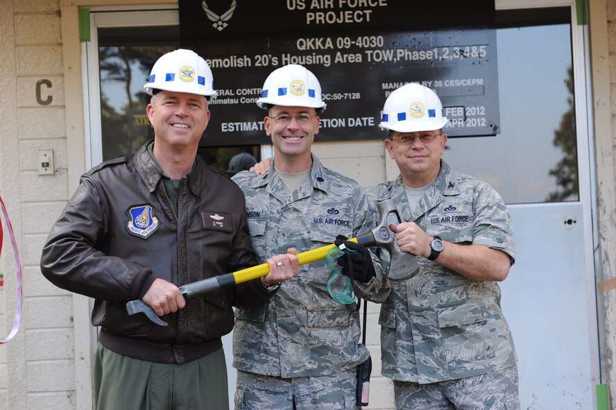 From left to right, Col. Van Wimmer, 35th Fighter Wing vice commander, Lt. Col. Dwayne Robison, 35th Civil Engineer Squadron commander, and Col. John Griffin, 35th Mission Support Group commander, help in the demolition of buildings in the 20 area housing here Nov. 14, Misawa Air Base, Japan. Demolition of these buildings is expected to be completed by May of next year. (U.S. Air Force photo/Airman 1st Class Kia Atkins) 
