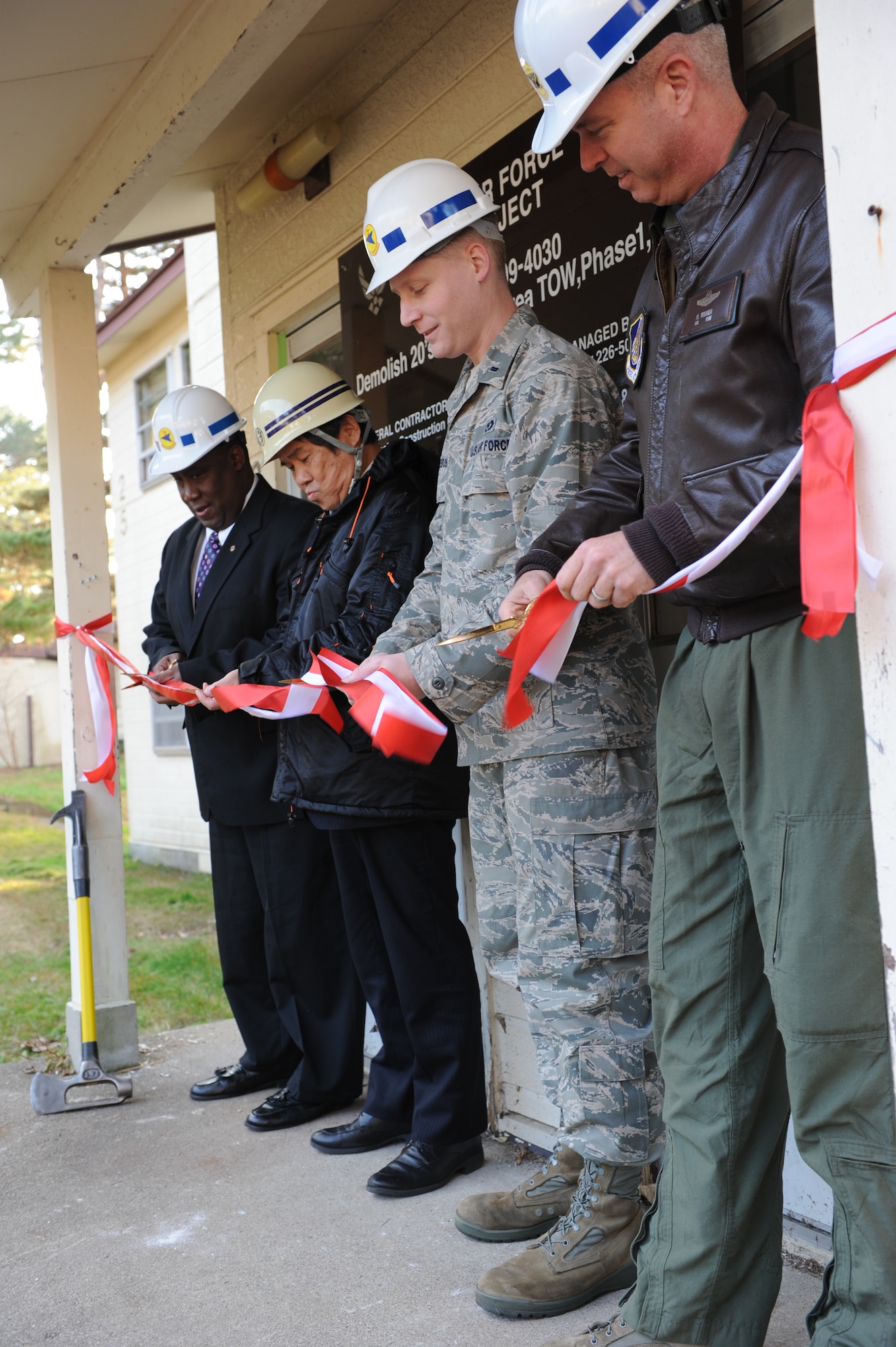 MISAWA AIR BASE, Japan – From left to right, Avery Borders, Chief Capital Asset Management for 35th Civil Engineer Squadron, Kenichi  Kawamura, Nishimatsu Construction Company deputy general manager, 1st Lt. Daniel Ledeboer, 35 CES, and Col. Van Wimmer, 35th Fighter Wing vice commander, cut the ribbon at the 20 area housing demolition ceremony here Nov. 14. Demolition of these buildings is expected to be completed by May of next year. (U.S. Air Force photo/Airman 1st Class Kia Atkins)