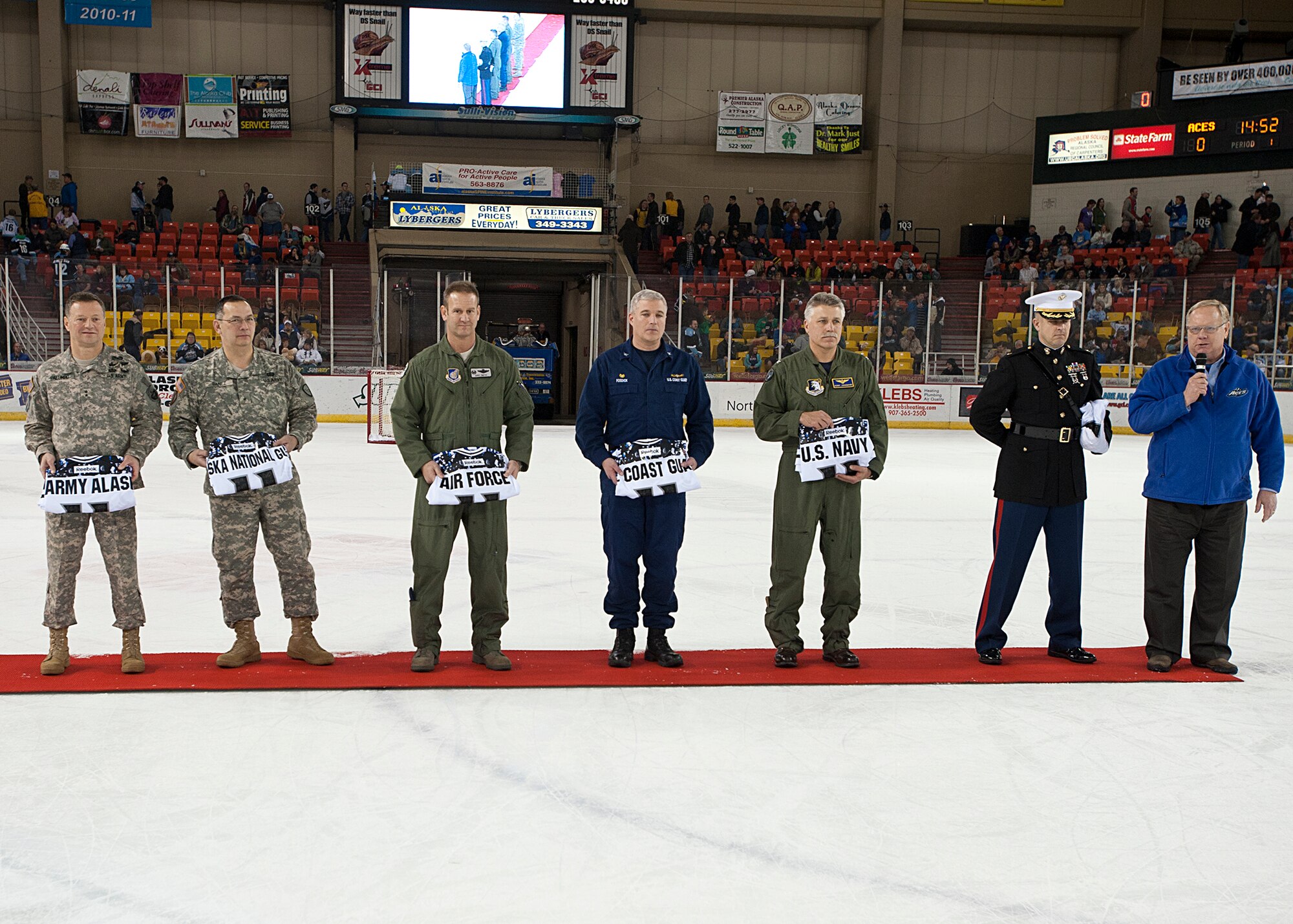 Senior representatives from each branch of military service receive Alaska Aces jerseys from Terry Parks, Alaska Aces managing member, during intermission of the Aces game Nov. 12, 2011.   The Alaska Aces honored veterans for their service with a military appreciation weekend. (U.S. Air Force photo/Staff Sgt. Zachary Wolf)