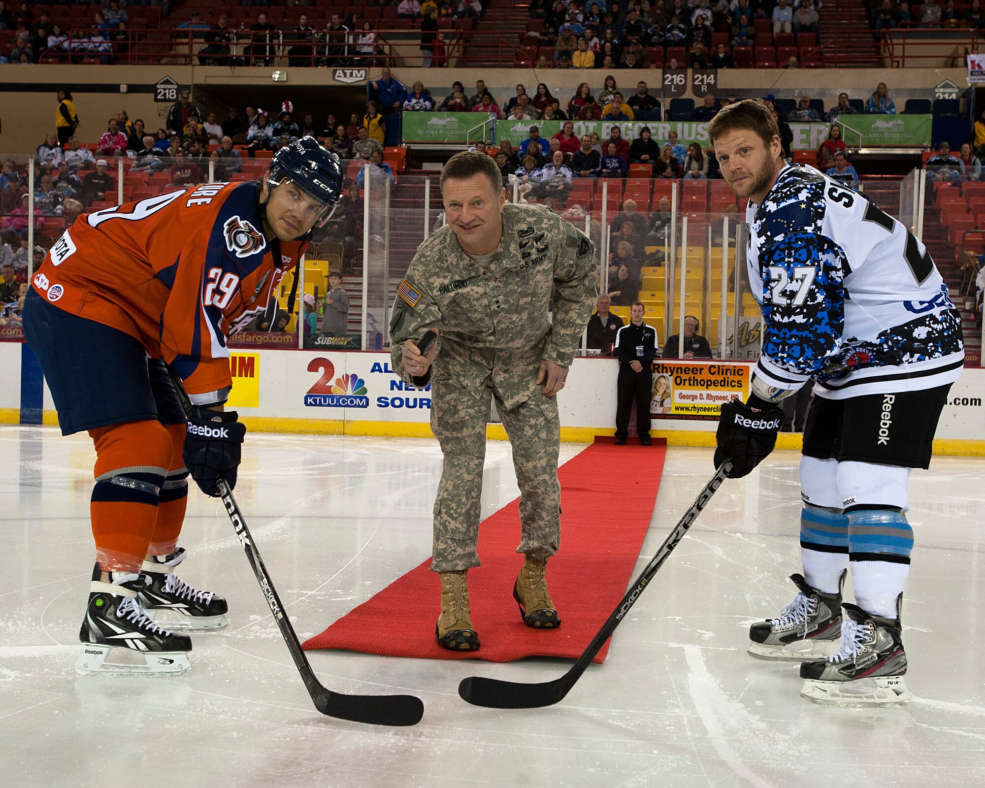 Maj. Gen. Raymond P. Palumbo, United States Army Alaska commander, drops the puck before an Alaska Aces game in Sullivan Arena, Anchorage, Alaska, Nov. 12, 2011.  The Alaska Aces honored veterans for their service with a military appreciation weekend. (U.S. Air Force photo/Staff Sgt. Zachary Wolf)