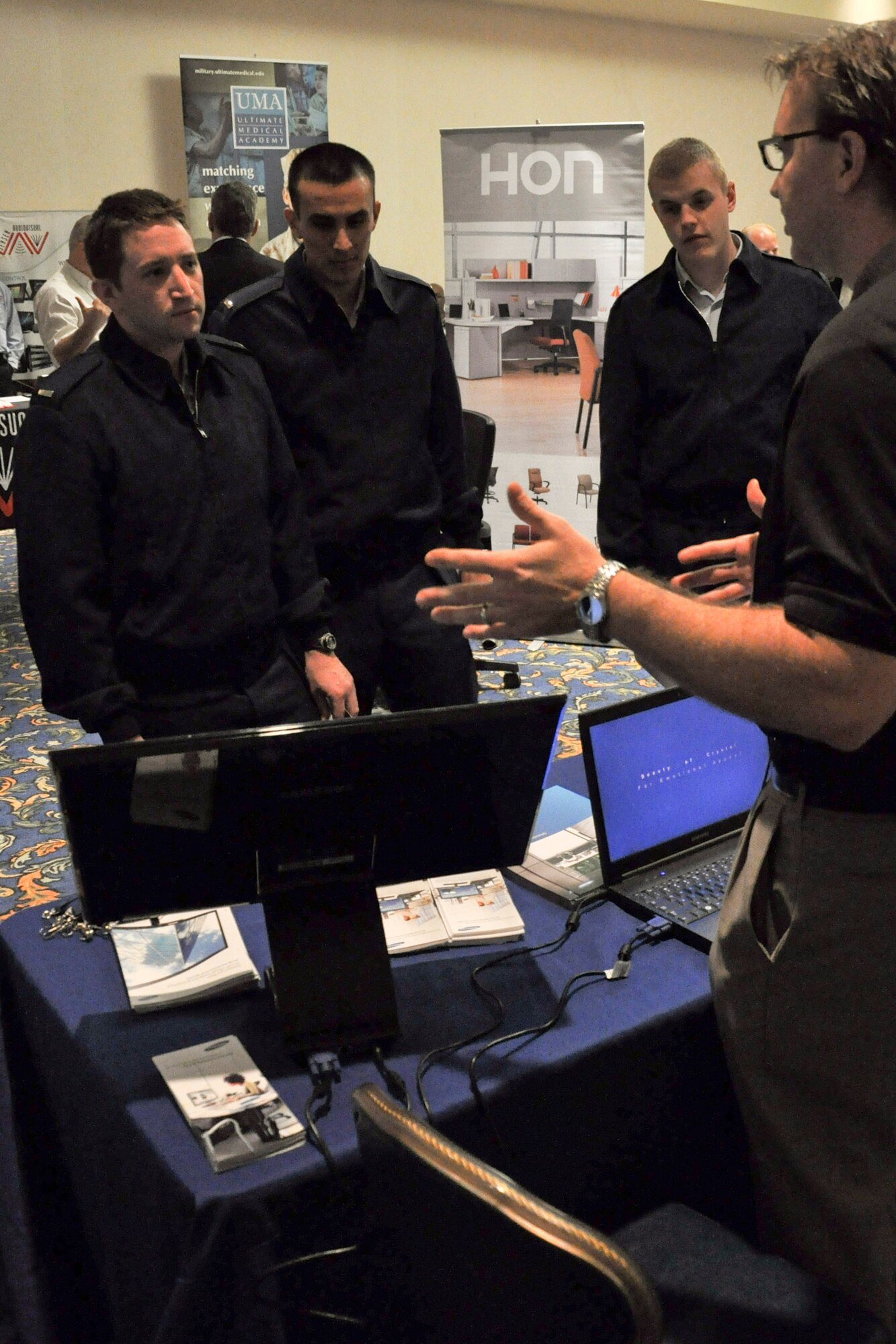 VANDENBERG AIR FORCE BASE, Calif. -- Officers from the 30th Space Communications Squadron listen to a vendor's information at the annual Technology Exposition at the Pacific Coast Club here Monday, Nov. 14th, 2011. More than 20 companies showcased their latest technologies at the event, which was open to all base personnel. (U.S. Air Force photo/Staff Sgt. Levi Riendeau)