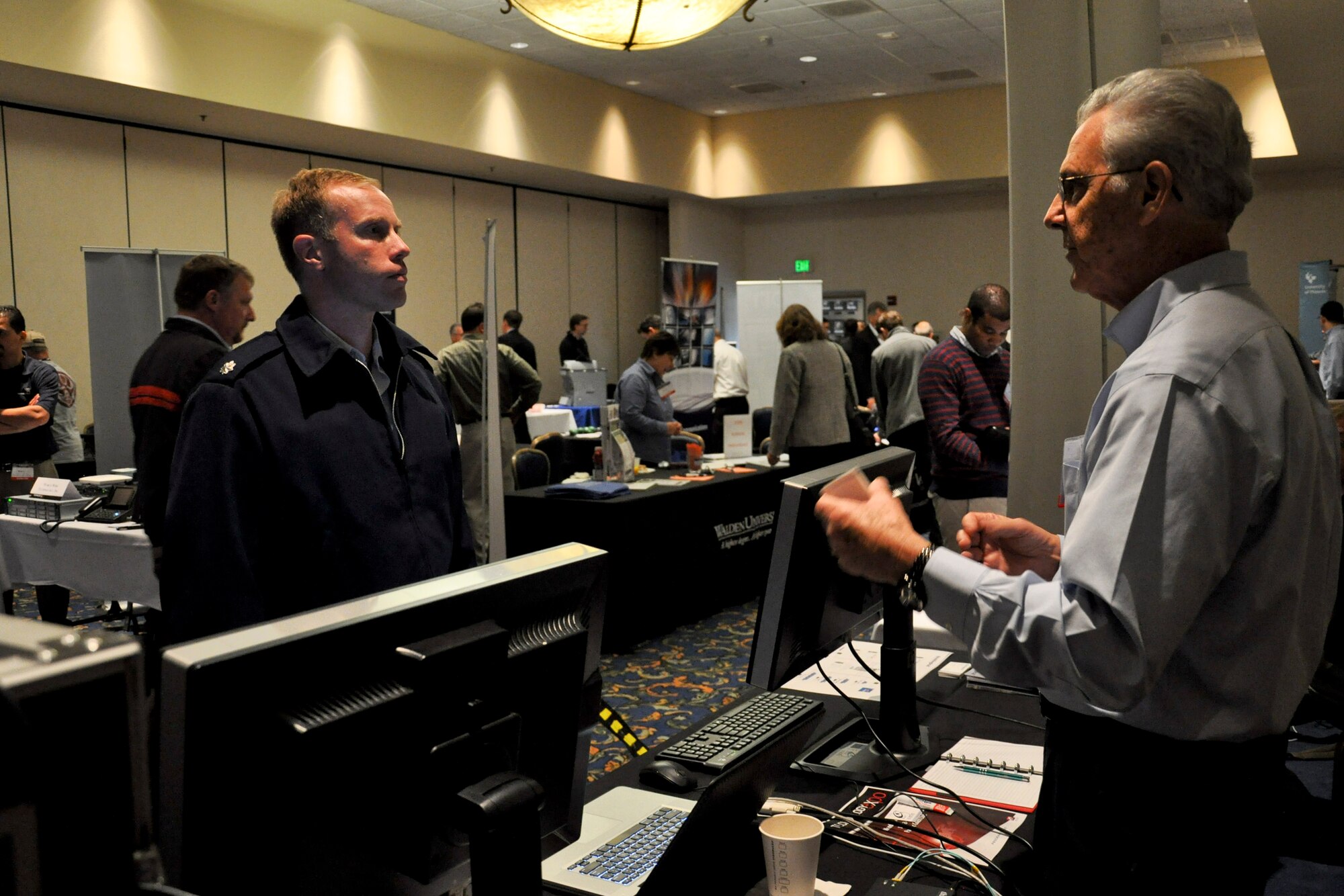 VANDENBERG AIR FORCE BASE, Calif. -- Lt. Col. Michael Anderson, 14th Air Force deputy director of communications, logistics and security, speaks with a vendor at the annual Technology Exposition at the Pacific Coast Club here Monday, Nov. 14th, 2011. More than 20 companies showcased their latest technologies at the event, which was open to all base personnel. (U.S. Air Force photo/Staff Sgt. Levi Riendeau)
