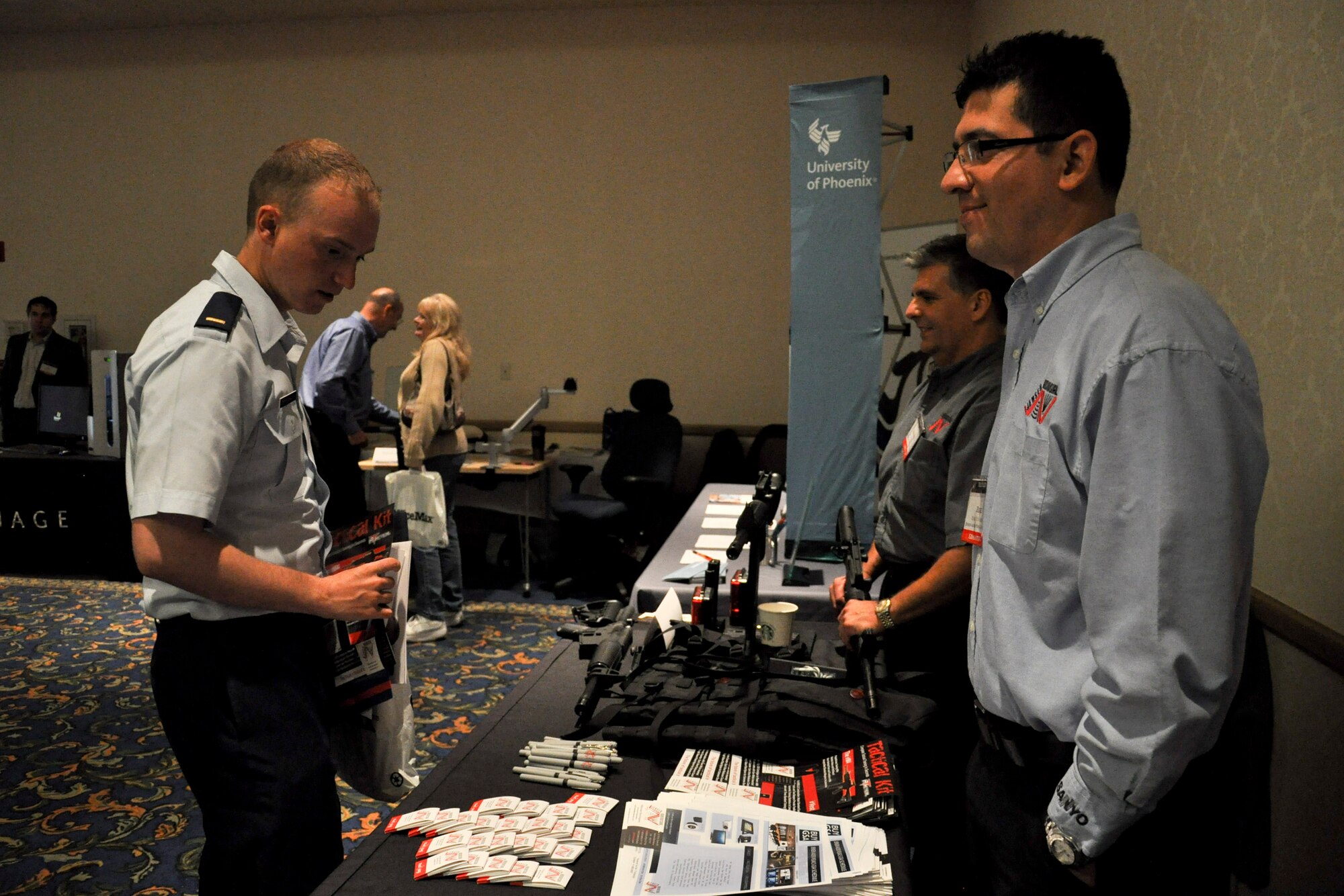 VANDENBERG AIR FORCE BASE, Calif. -- 2nd Lt. Jonathan Deffenbaugh, 4th Space Launch Squadron infrastructure engineer, views combat training gear at the annual Technology Exposition at the Pacific Coast Club here Monday, Nov. 14th, 2011. More than 20 companies showcased their latest technologies at the event, which was open to all base personnel. (U.S. Air Force photo/Staff Sgt. Levi Riendeau)