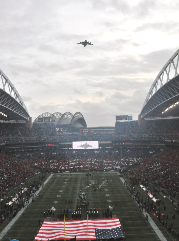 A C-17 Globemaster III roars over Century Link Field in Seattle on Nov. 13 as part of a flyover and U.S. National Anthem formation in honor of Veteran's Day.  An aircrew from the 446th Airlift Wing at MCChord Field flew the mighty aircraft over the field just as the final notes of The Star Spangled Banner were belted out. The air was cool and crisp; a perfect day for some good old American football. (U.S. Air Force photo/2nd Lt. Denise Hauser
