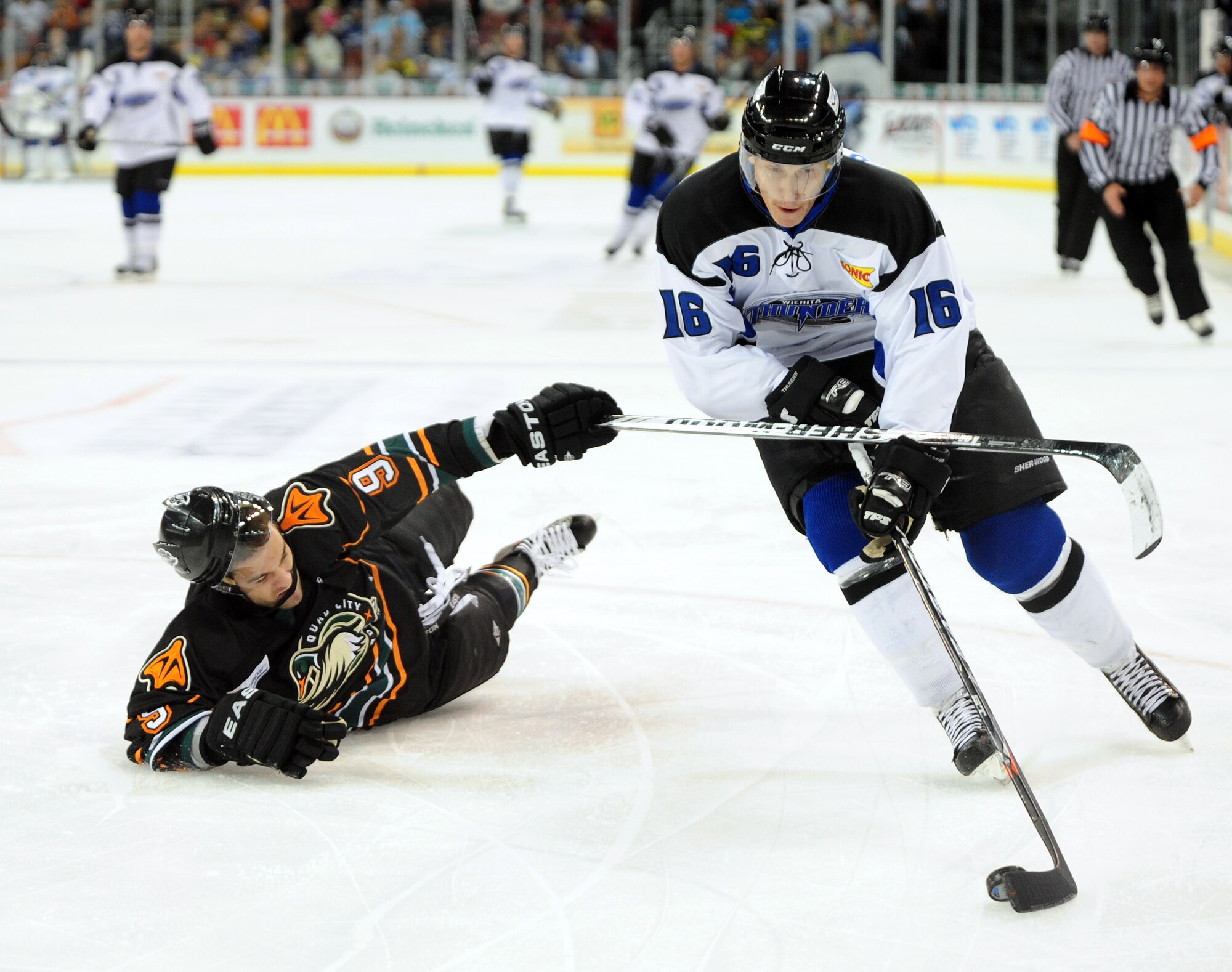 Matt Robinson, Wichita Thunder forward, pushes through Tyler Gilmore, Quad City Mallards defender, during a game Nov. 11, 2011, Wichita, Kan. The Wichita Thunder beat the Mallards 4-1. (U.S. Air Force photo by 1st Lt. Zach Anderson)