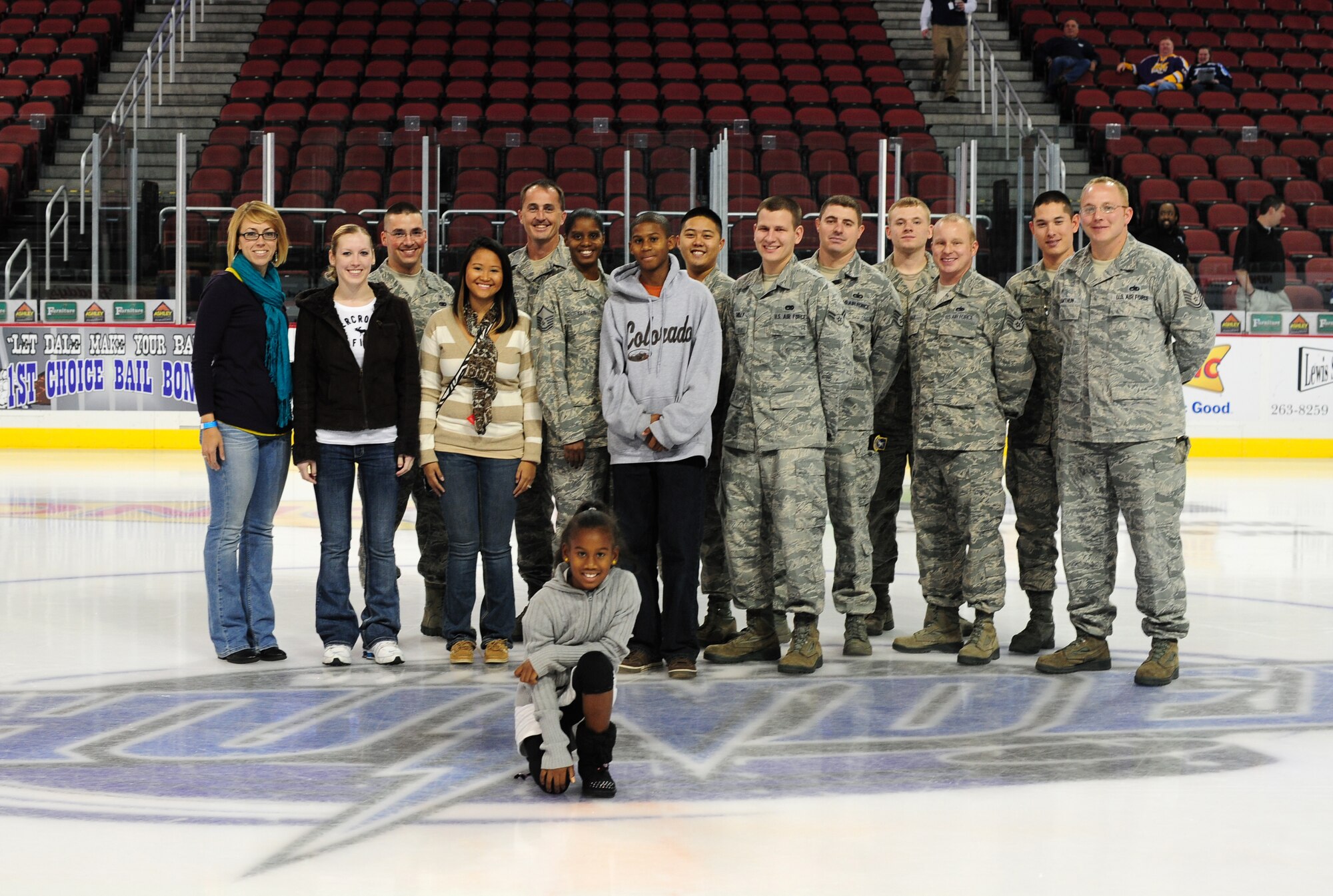 McConnell Airmen and family members pose for a picture before the Wichita Thunder hockey game at Intrust Bank Arena, Wichita, Kan., Nov. 11, 2011. The Thunder honored Airmen from McConnell as part of a Veterans Day tribute. (U.S. Air Force photo by Senior Airman Courtney Witt)