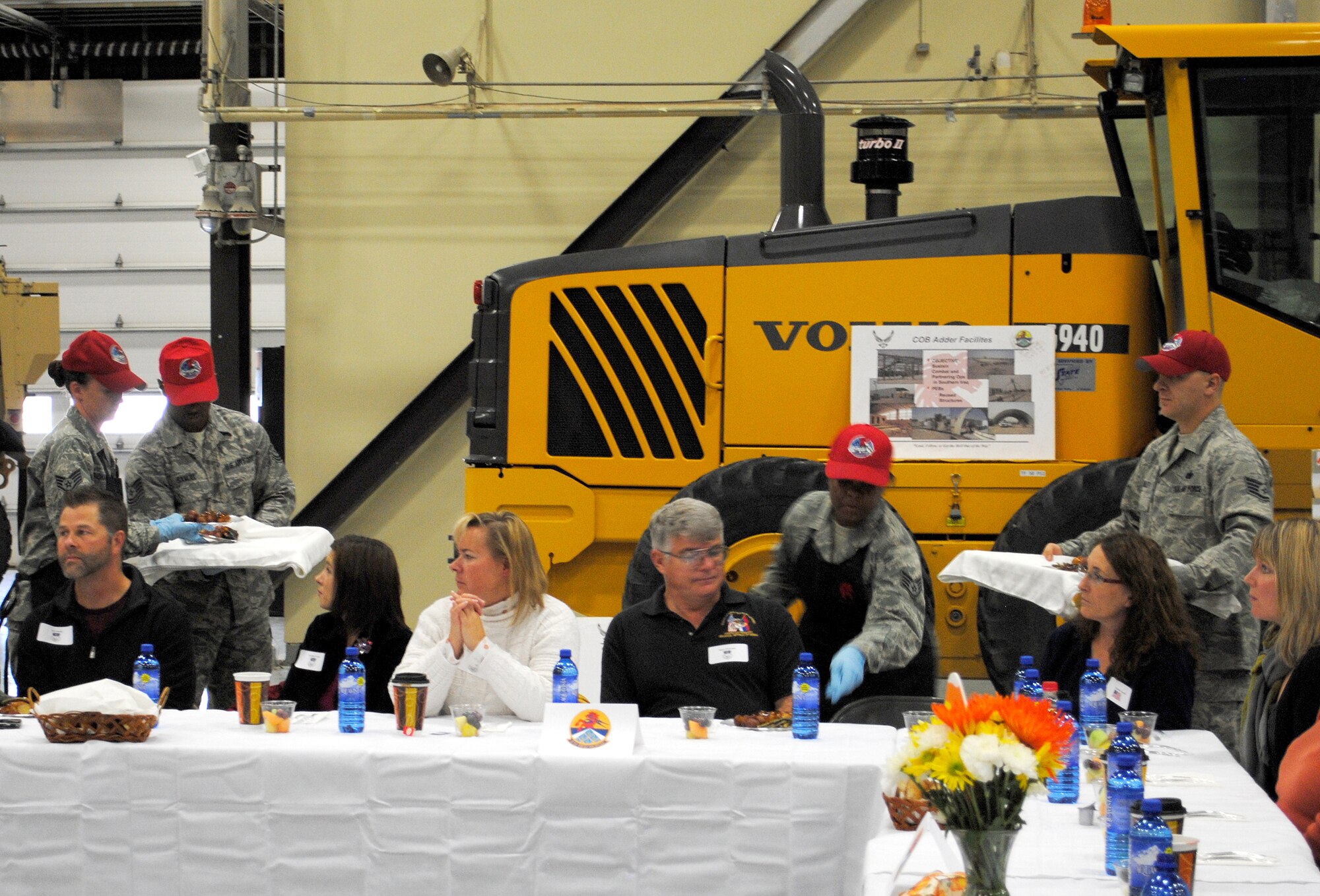 Members of the 819th RED HORSE Squadron's services team serve the CIVAIRES guests during the luncheon part of their orientation tour Nov. 1. In the background is one of the many displays guests were allowed to browse following their meal. (U.S. Air Force photo/Airman Cortney Paxton)