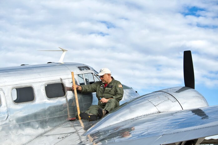 Francois Bergeon, Beechcraft C-45 Expeditor aircraft pilot, checks his fuel level with a dip stick during the 2011 Aviation Nation Open House, Nov. 12, at Nellis Air Force Base, Nev. The C-45 flew in the Heritage Aerial Gunnery/Bomber Demonstration during the two-day air show. Aviation Nation celebrates 70 years of airpower in Las Vegas. (U.S. Air Force photo by Lawrence Crespo/Released)