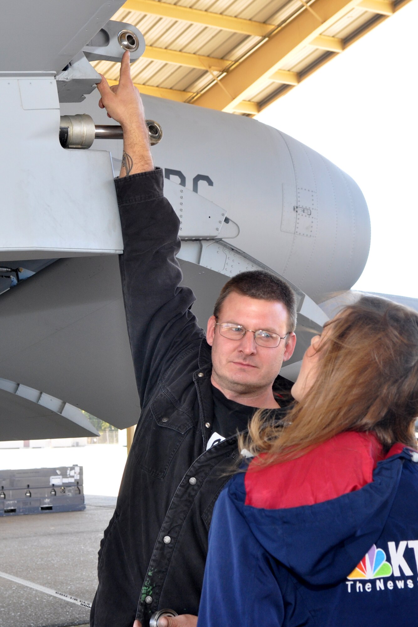 Zach Perry, who is an Air Reserve Technician (ART) assigned to the 917th Maintenance Squadron, explains how a structural repair for an A-10 Thunderbolt II will be completed, to Jenna Zibton at Barksdale Air Force Base, La., Nov. 3, 2011. Zibton, who is a reporter for KTAL Channel 6 in Shreveport, La., was at Barksdale to report on the Reservists and their innovative aircraft repair methods that are saving American taxpayer dollars. Perry is also a Staff Sergeant in the Air Force Reserve and the aircraft metals technology supervisor. (U.S. Air Force photo by Master Sgt. Jeff Walston/Released) 