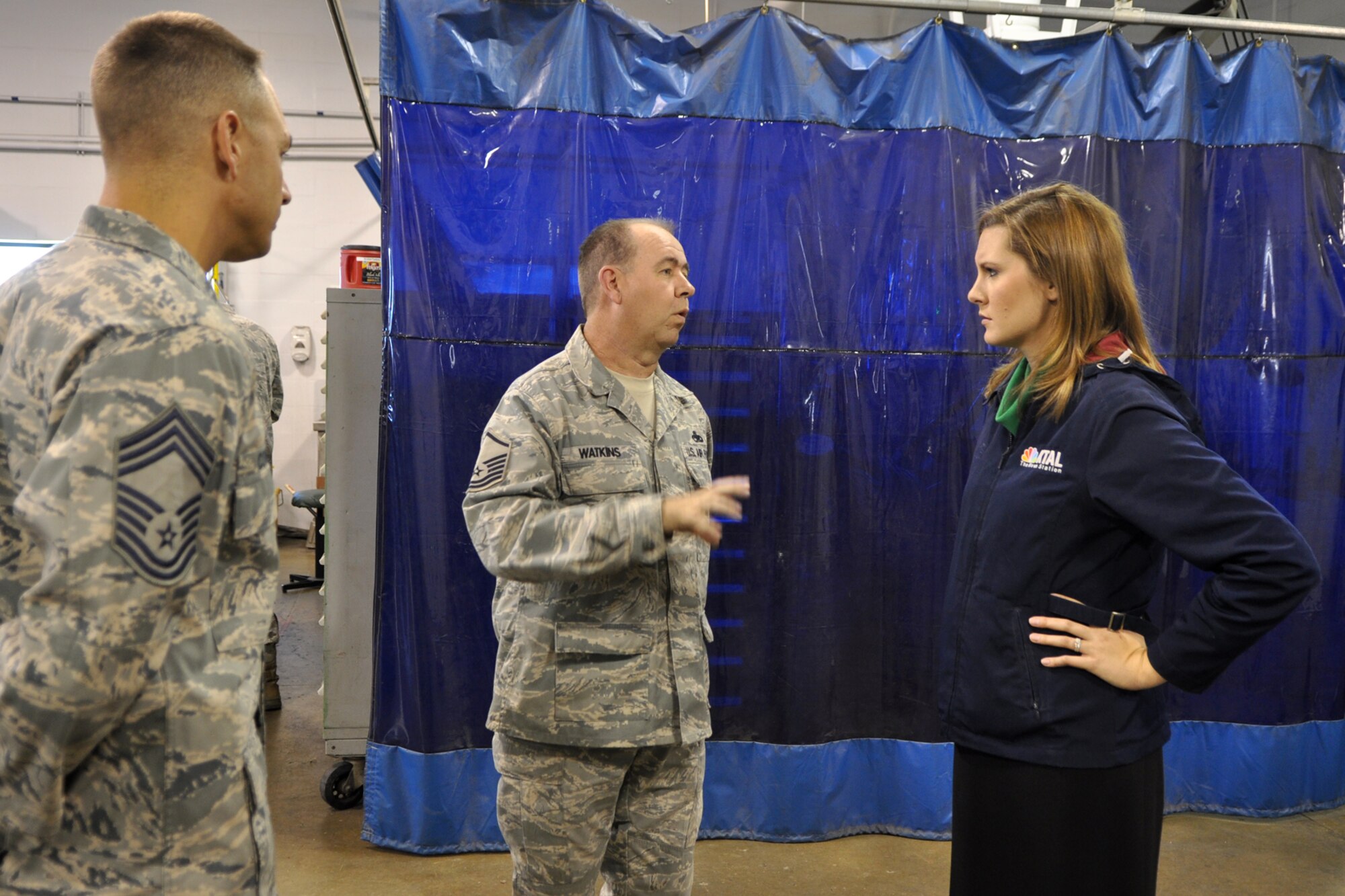 Chief Master Sgt. Derek Conrad looks on as Master Sgt. Kelly Watkins, who is the aircraft metals technology supervisor for the 307th Maintenance Squadron, explains a structural repair for an A-10 Thunderbolt II, to Jenna Zibton at the Metals Technology shop on Barksdale Air Force Base, La., Nov. 3, 2011. Zibton, who is a reporter for KTAL Channel 6 in Shreveport, La., was at Barksdale to report on the Reservists and their innovative aircraft repair methods that are saving American taxpayer dollars. Conrad is the quality assurance superintendent for the 917th Fighter Group at Barksdale. (U.S. Air Force photo by Master Sgt. Jeff Walston/Released) 