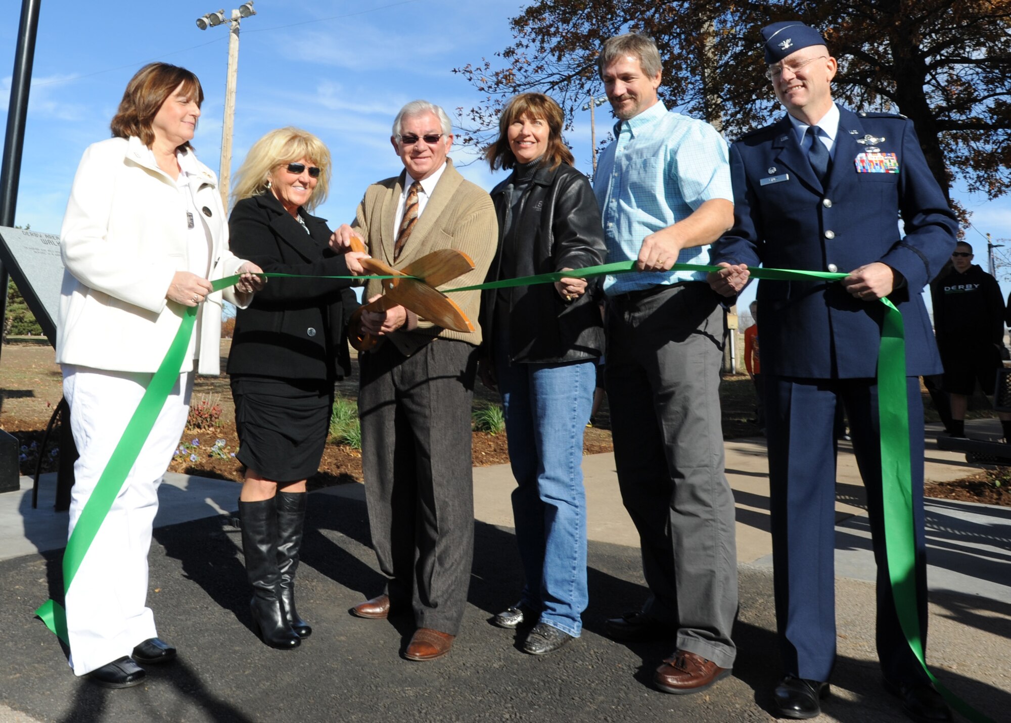 The Derby Area Veterans Memorial – Walk of Freedom was officially dedicated and open on Veterans Day Nov. 11, 2011, Derby, Kan. Debora Morris Nelson, and Dion Avello, mayor of Derby, hold the ceremonial sheers for the opening of the memorial. Nelson had the idea for a memorial in Derby after a cross-country drive more than five years ago.  (U.S. Air Force photo/ Airman 1st Class Laura L. Valentine)