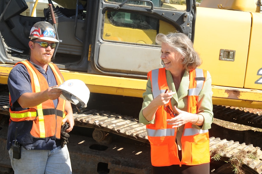 Kathy Wells, wife of 9th Air Force commander Maj. Gen. Lawrence Wells, finishes her demolition part in the Family Housing Redevelopment Commencement here, Nov. 14, 2011. The first phase of construction involves building 192 homes and community amenities, destroying 680 homes and eventually providing 630 new residences by 2015. (U.S. Air Force photo by Airman 1st Class Hunter Brady/Released)
