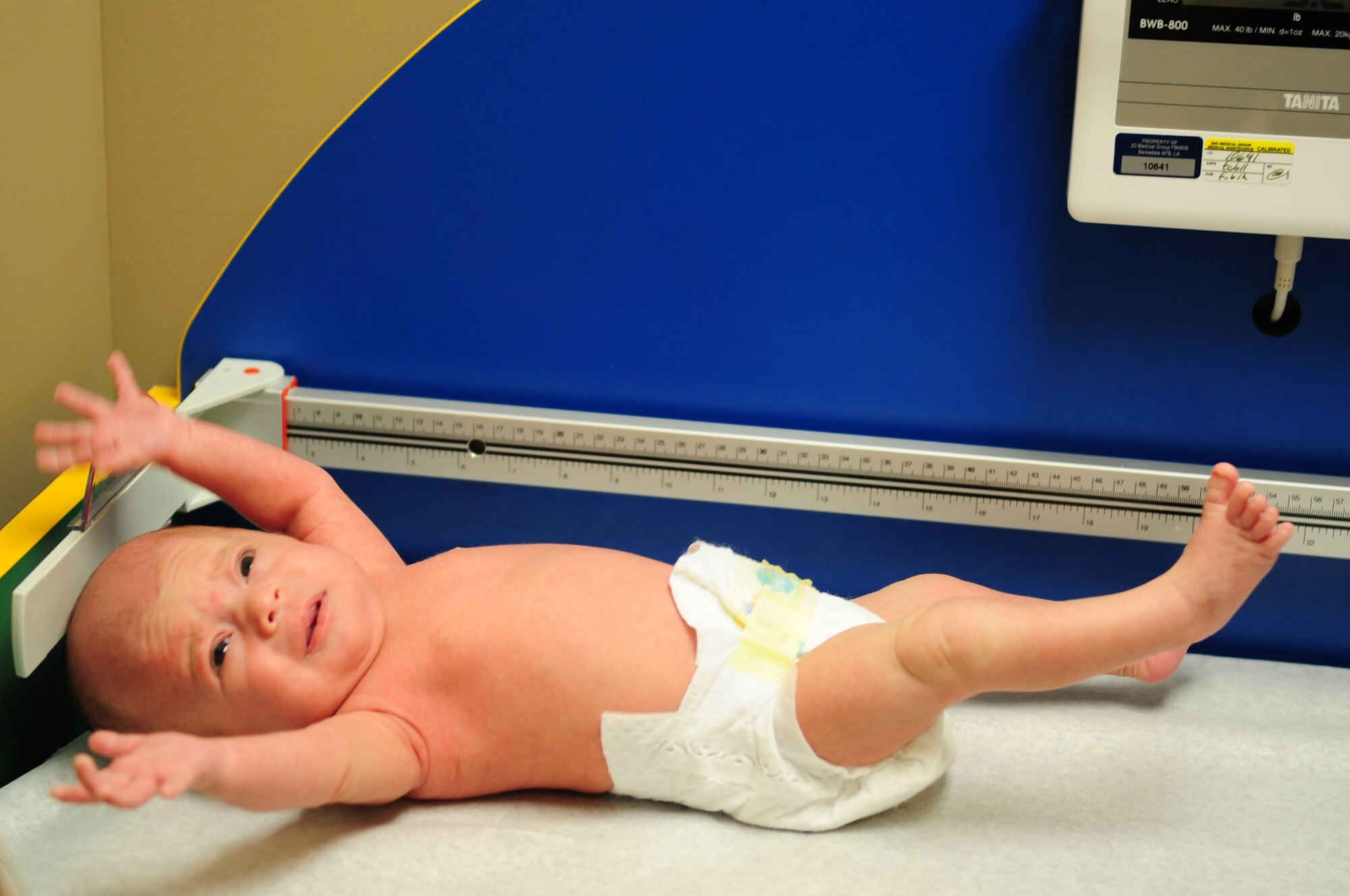 Cali Chiti, 1 month, daughter of Brianna and Senior Airman Michael Chiti, 2nd Contracting Squadron, reacts to being placed on a scale during her pediatric examination at the clinic on Barksdale Air Force Base, La., Nov. 3.  Children are weighed each visit to ensure they are growing at a healthy rate. (U.S. Air Force photo/2nd Lt. Victoria Lalich)(RELEASED)