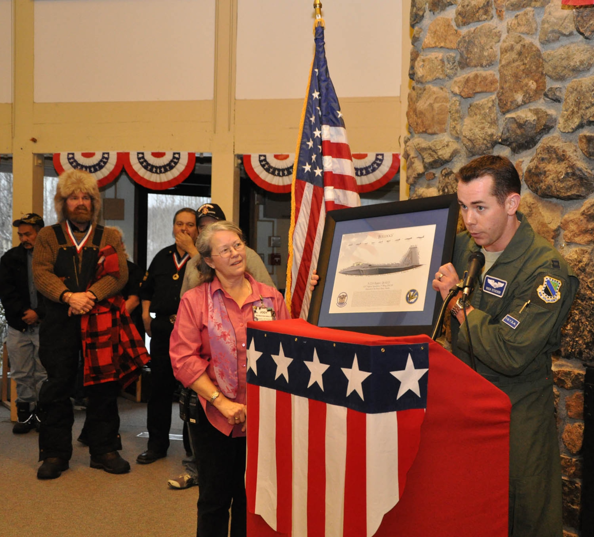 An F-22 lithograph signed by the Reserve and active duty pilots is presented to the Alaska Veterans and Pioneers Home in Palmer, Alaska Nov. 11.