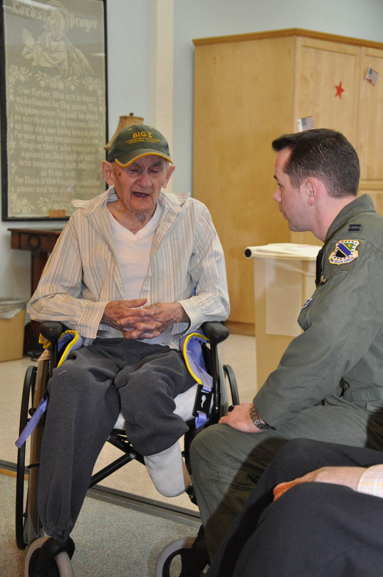 An Airman spoke with an Alaska Veterans and Pioneers Home resident in Palmer, Alaska Nov. 11.