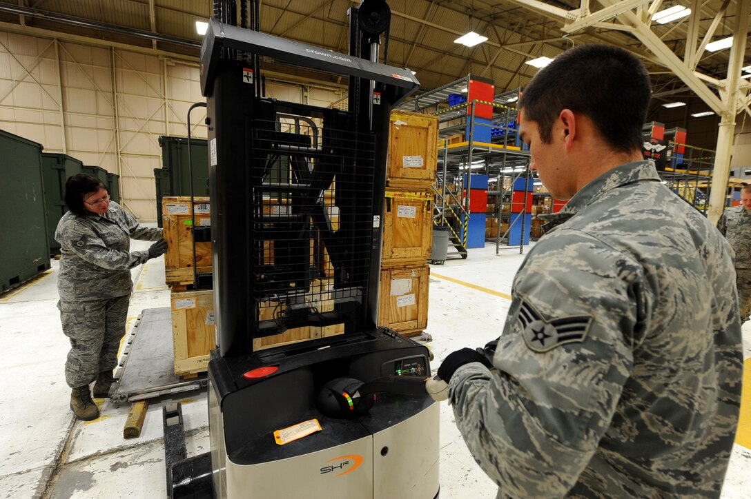 Staff Sgt. Ludmilla Alvarado and Senior Airman Chris Robinson 28th Logistics Readiness Squadron aircraft parts technicians, prepares a pallet of aircraft parts to be shipped at Dock 63 on Ellsworth Air Force Base, S.D., Nov. 3, 2011. The 28th LRS prepares aircraft parts to be shipped to deployed locations. (U.S. Air Force photo by Airman 1st Class Zachary Hada/Released)