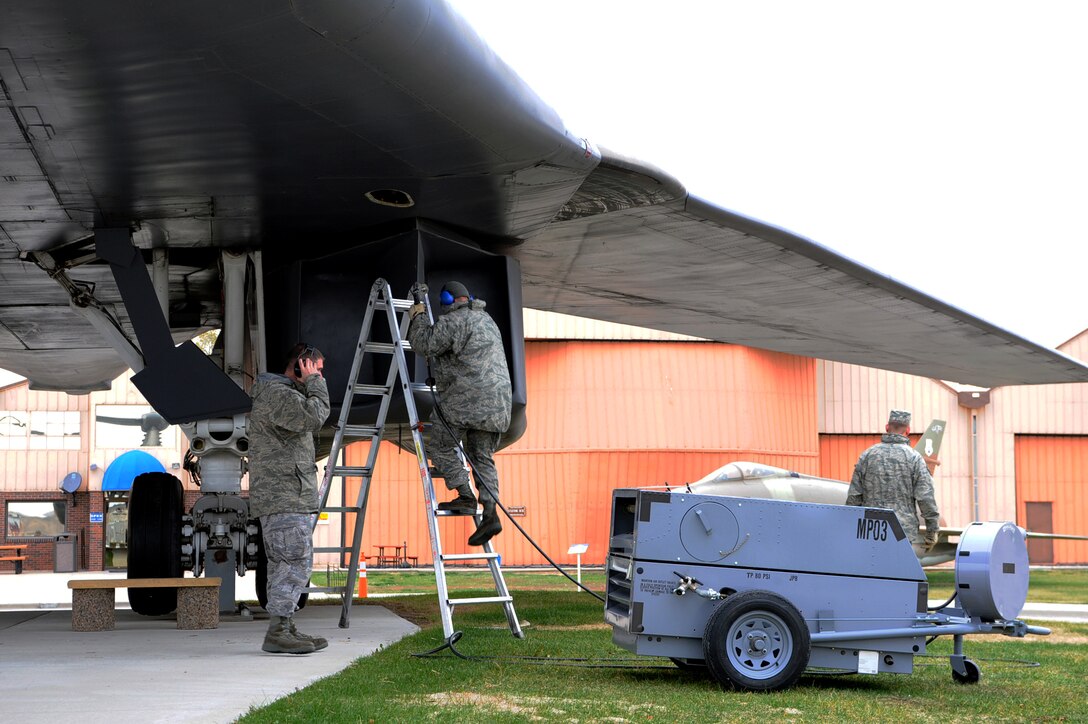 Staff Sgt. Bryan Auxier, 28th Maintenance Squadron aircraft repair and reclamation craftsman, supervises  Airman 1st Class Michael Souza, 28th MXS aircraft recovery journeyman, as he prepares to manually sweep the wings back on a B-1 Lancer at the South Dakota Air and Space Museum in Box Elder, S.D., Nov. 1, 2011. The 28th MXS changed the flight configuration for the visitors of the museum. (U.S. Air Force photo by Airman 1st Class Zachary Hada/Released)