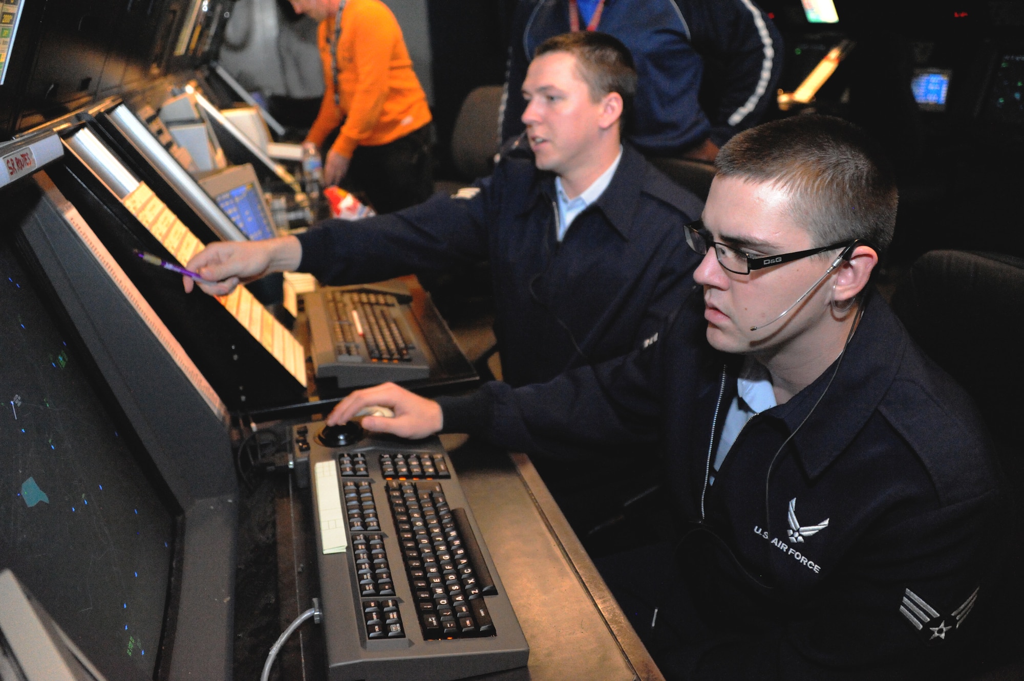 Senior Airman David Vile, Air traffic control specialist with the 305th Operation Support Squadron radar approach control, provides radar approach information to an aircraft Oct. 31 here. The civilians and Airmen with RAPCON have a 24/7, 365 days a year duty to maintain a safe flow of air-traffic to ensure all aircraft stay on the correct flight plan. (U.S. Air Force photo by Airman Ryan Throneberry/Released)