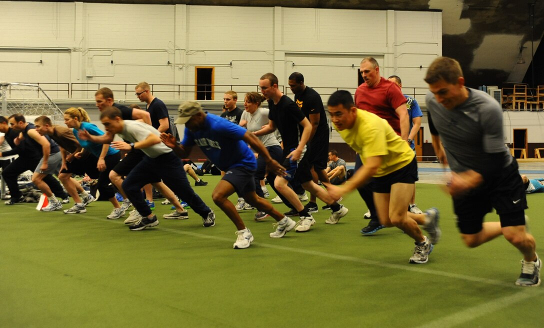 Col. Trent Edwards, 28th Mission Support Group commander, (center), runs with Airmen in a sprinting exercise at the Pride Hangar on Ellsworth Air Force Base, S.D., Oct. 27, 2011. Edwards led Airmen in a multi-squadron physical training session that pushed them to do their best. (U.S. Air Force photo by Airman 1st Class Zachary Hada/Released)