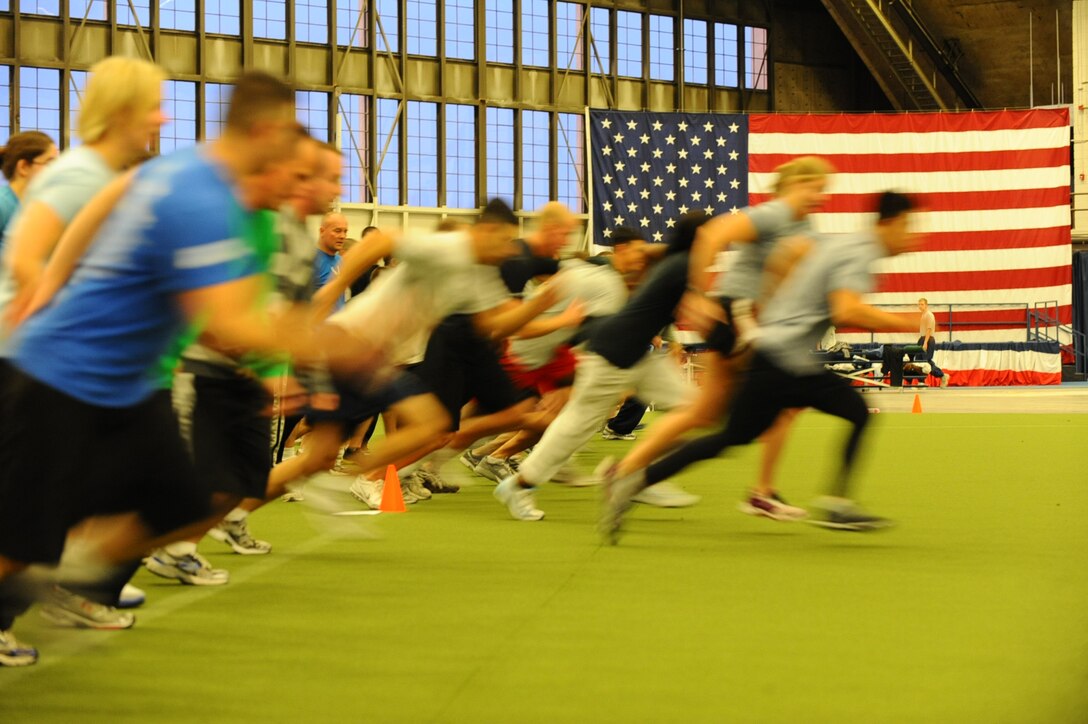 Airmen do wind sprints during a physical training exercise at the Pride hangar on Ellsworth Air Force Base, S.D., Oct. 27, 2011. Multiple squadrons joined the PT session led by Col. Trent Edwards, 28th Mission Support Group commander, who motivated Airmen to be fit to fight. (U.S. Air Force photo by Airman 1st Class Zachary Hada/Released)