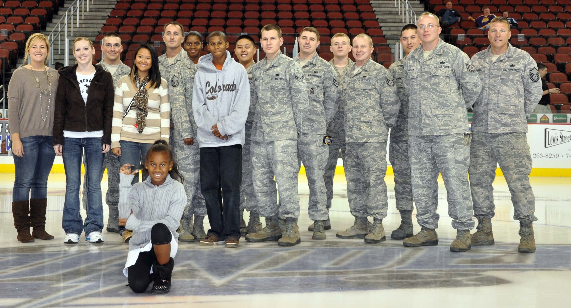 A group of McConnell Air Force Base Airmen and family members pose on the ice prior to a Wichita Thunder ice hockey game game, Nov. 11, 2011.  Several Airmen were honored for their service during the Veterans Day game activities.  (U.S. Air Force photo by 1st Lt. Zach Anderson)